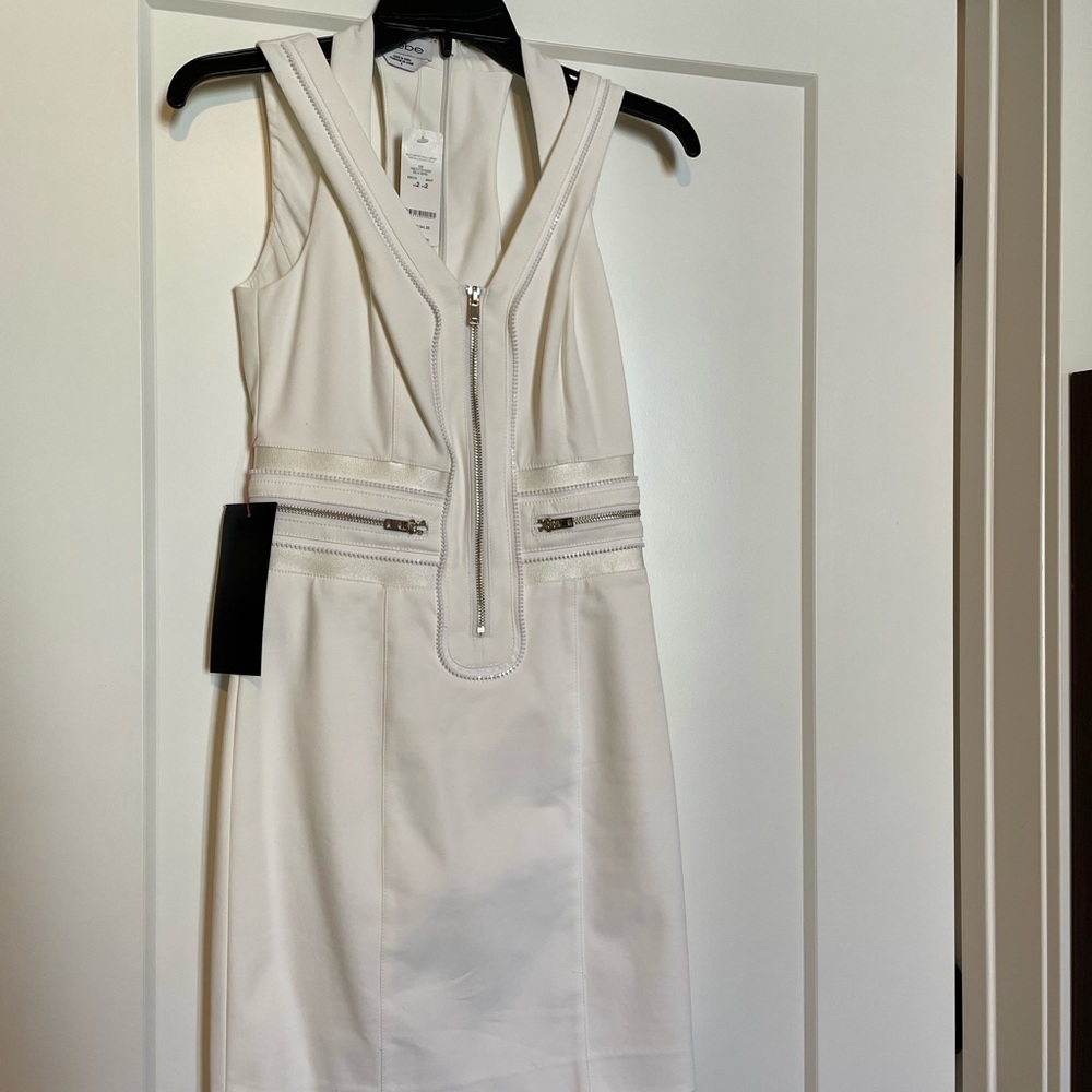 White bebe dress. Never worn. With tags. Zips in back.